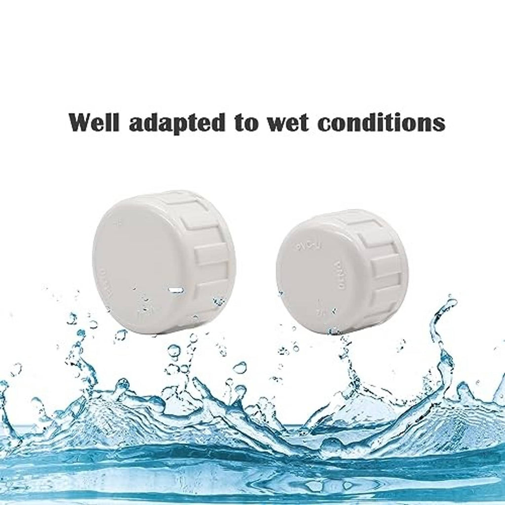 White PVC pipe end cap plugs with ridged exterior and closed top for sealing female threads