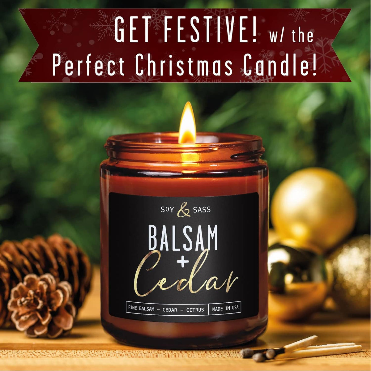 Amber glass soy candle jar with flame on a decorative holiday table