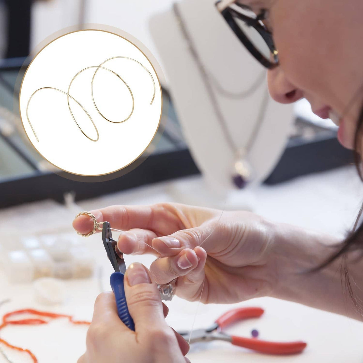 Gold-plated solder wire coil placed for jewelry soldering, in hand close-up
