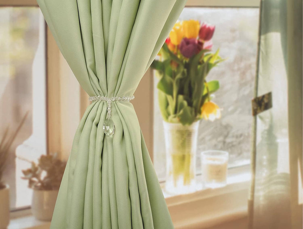 Crystal beaded curtain tieback fastened at the center with hanging teardrop pendant