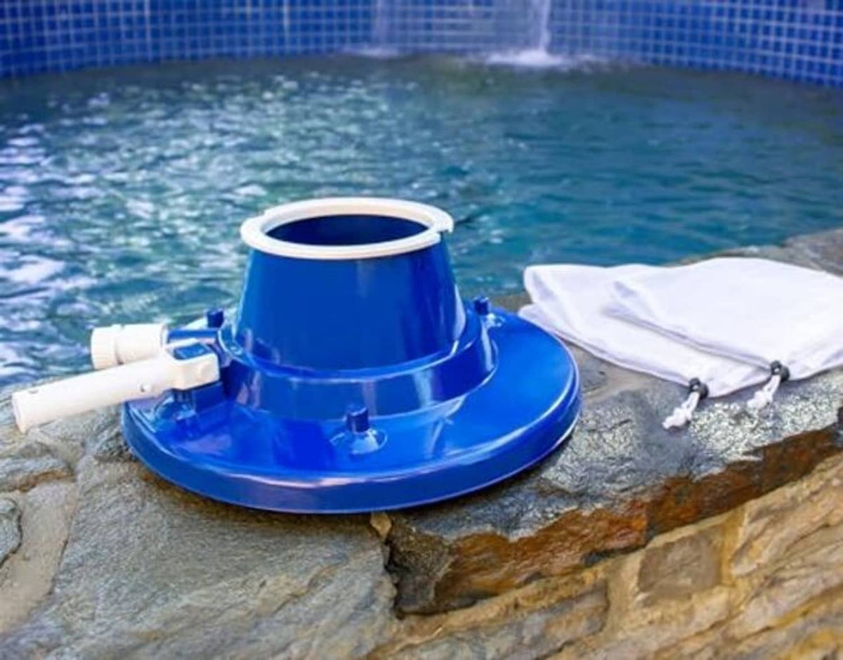 Blue pool leaf vacuum head with white collection bag on pool edge