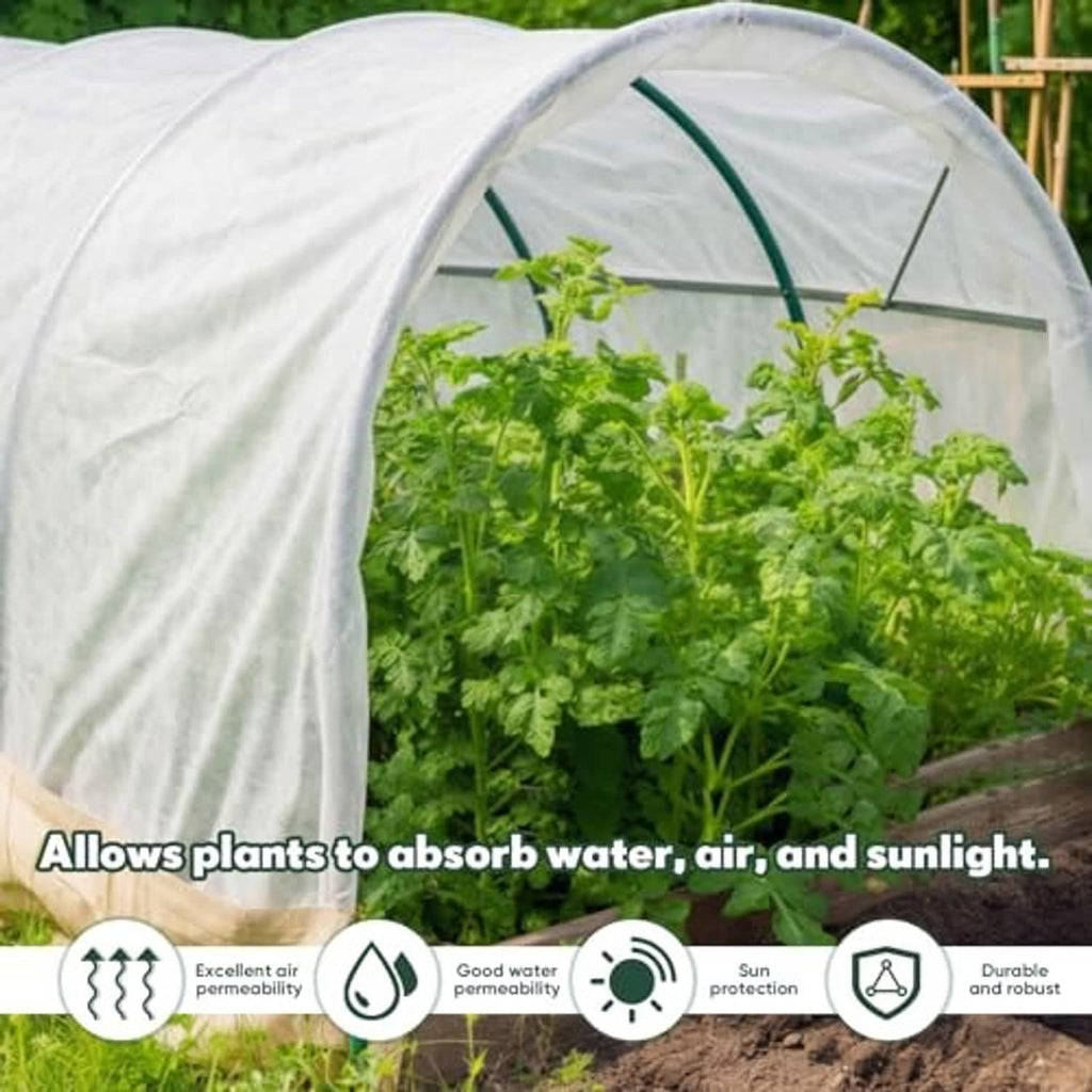 Large white plant cover tunnel made of non-woven fabric over leafy plants