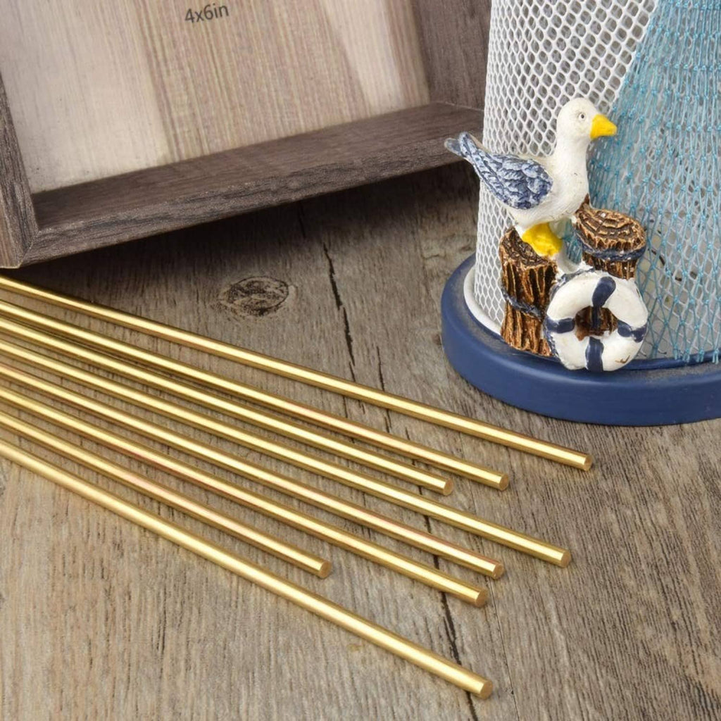 Brass round rods laid flat, bright gold color, smooth straight bars with even ends.