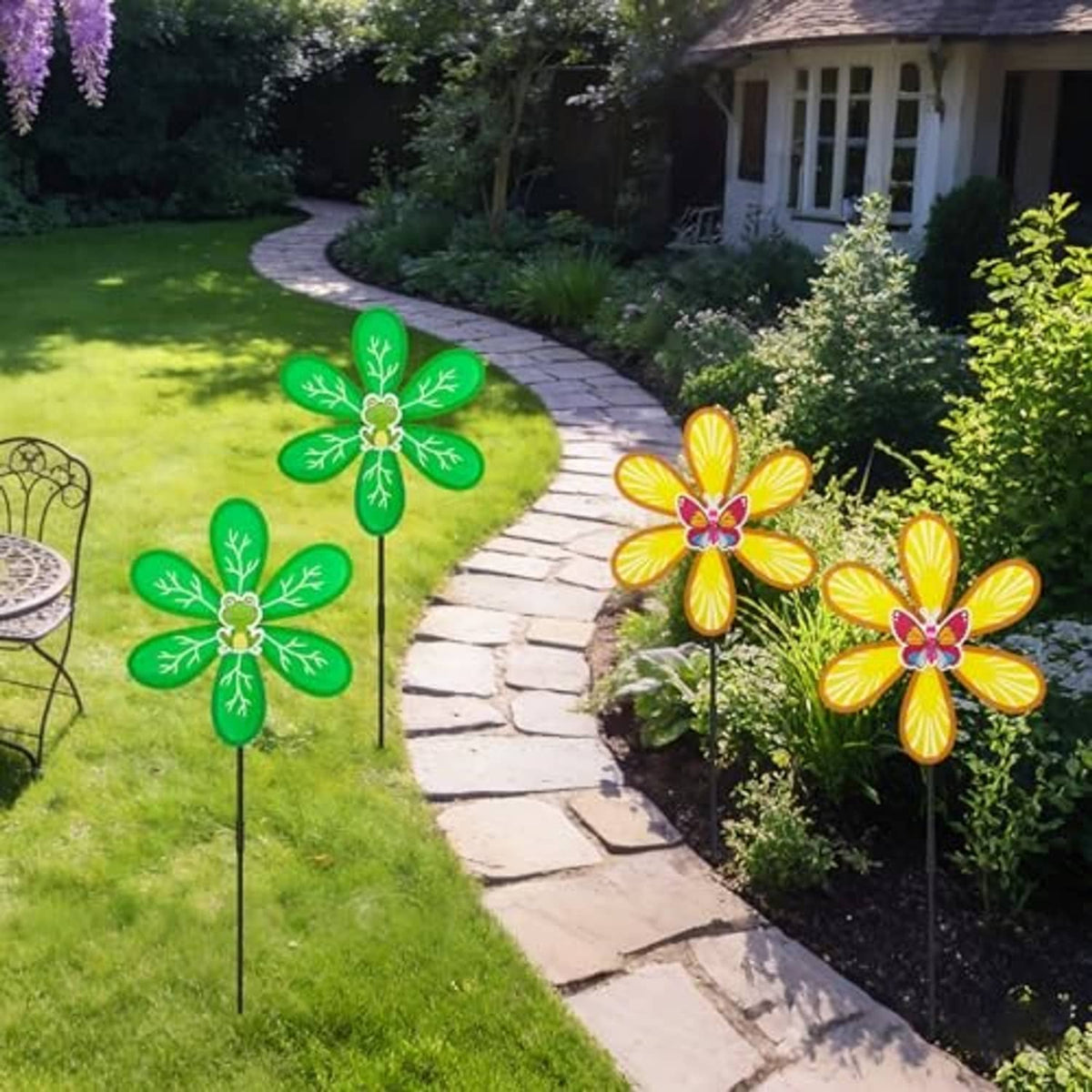 Four wind spinners with green and yellow petals and butterfly centers on black stakes