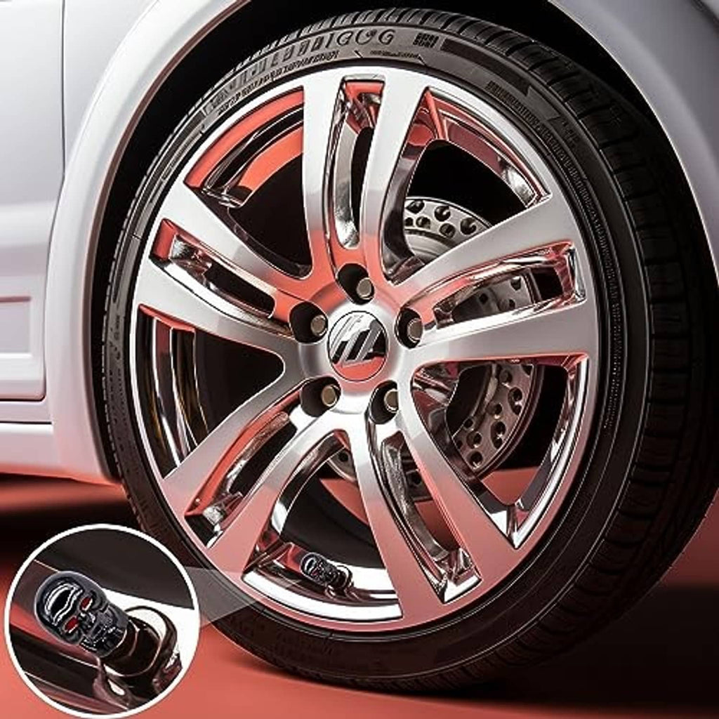 Skull valve stem cap, glossy black with red eyes, close-up on wheel valve