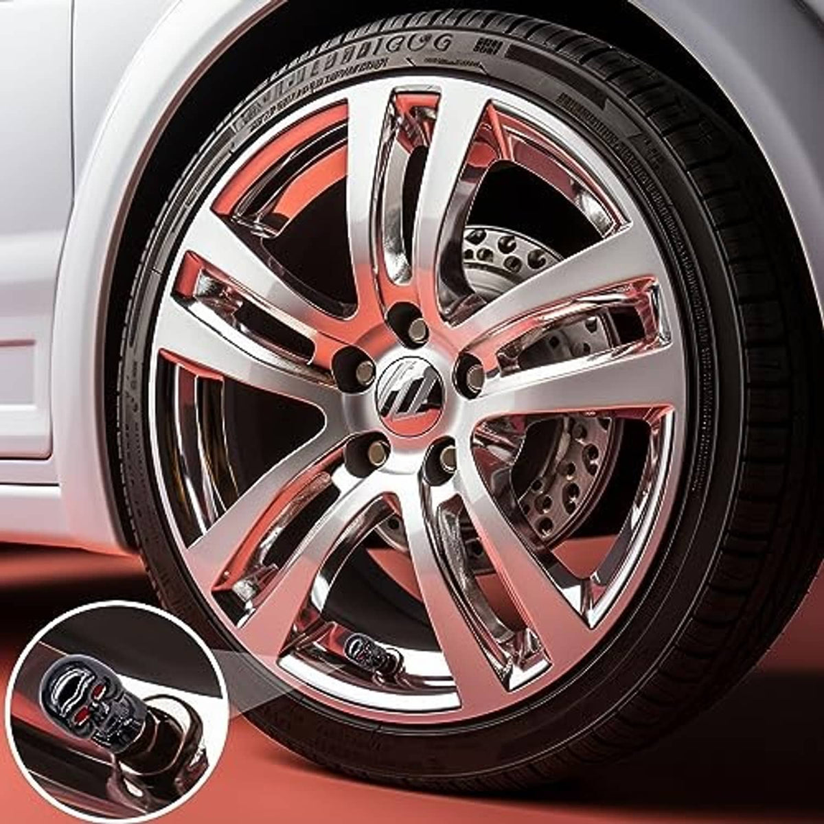 Skull valve stem cap, glossy black with red eyes, close-up on wheel valve