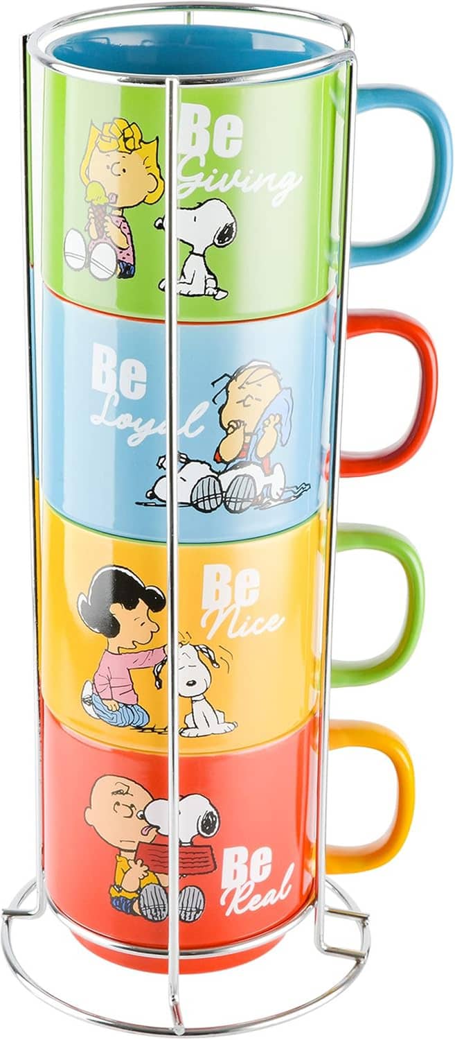 Stackable Snoopy stoneware mugs on metal rack, four-panel Be-themed artwork design.