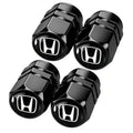 Set of black metal tire valve stem caps with Honda logo, hex design