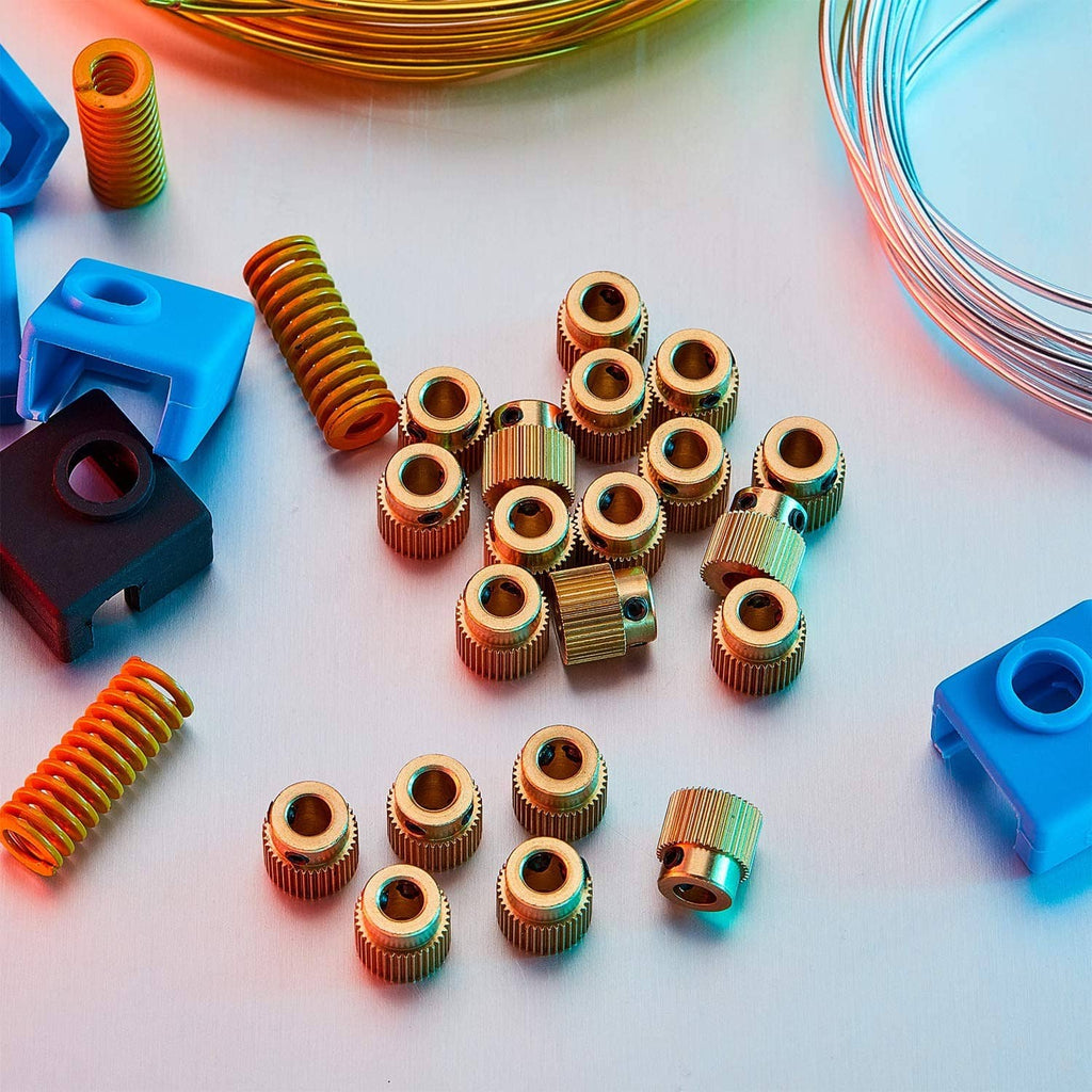 Assorted brass extruder drive gears, ribbed cylinders with black side inserts