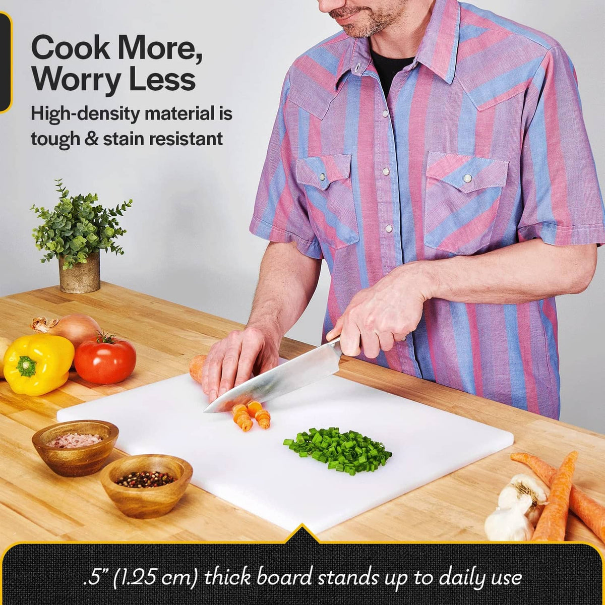 White plastic cutting board on wooden counter, chopped ingredients and knife