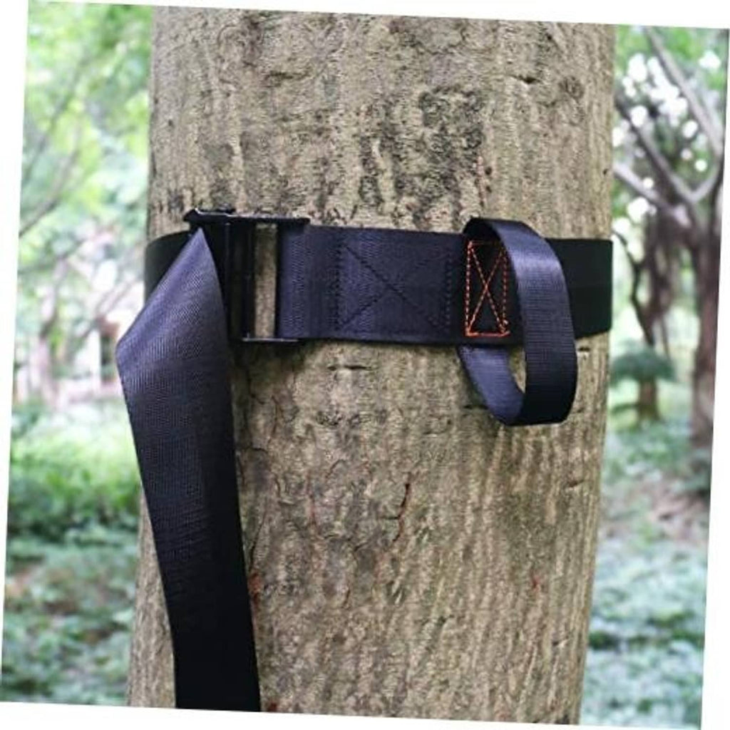 Navy nylon tree strap with buckle and tie loop, secured around a tree trunk