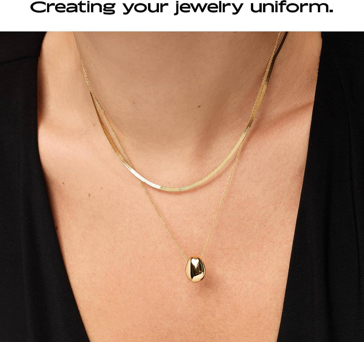 Gold-plated pebble pendant necklace on neckline, small oval pendant on a thin chain