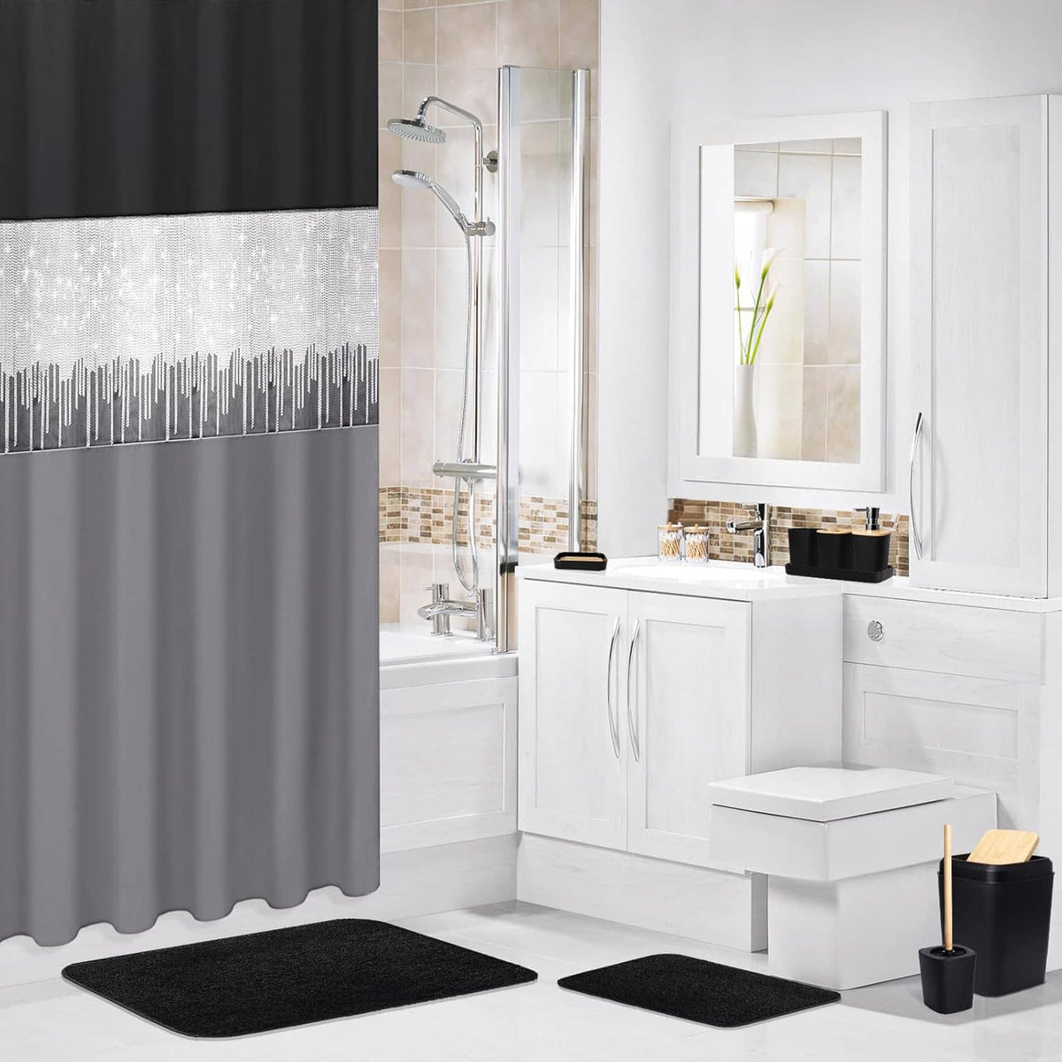 Black and gray shower curtain with two black bathroom rugs in a white bathroom