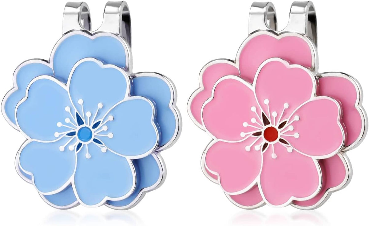 Two flower magnetic hat clips—blue and pink—with silver metal spring clips