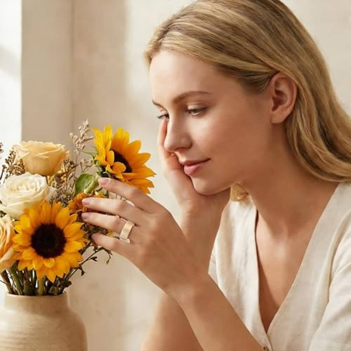 Floral silicone ring cover on finger, transparent with gold-tone floral accents.