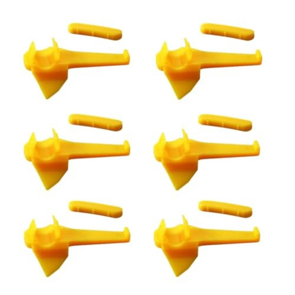 Multiple yellow plastic tire changer inserts with fork tips and short mounting shanks