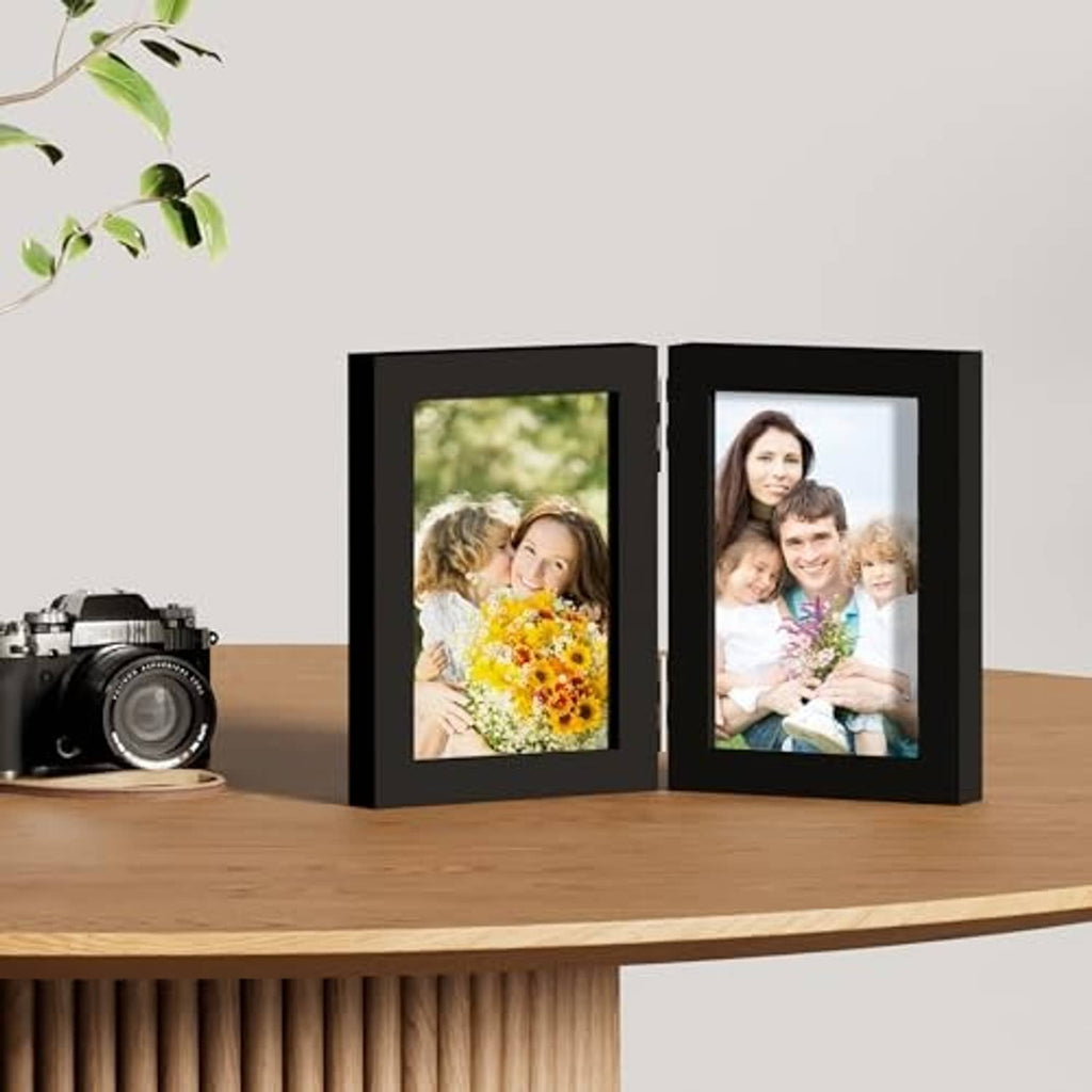 Black double vertical photo frame on tabletop, hinged display with two family photos
