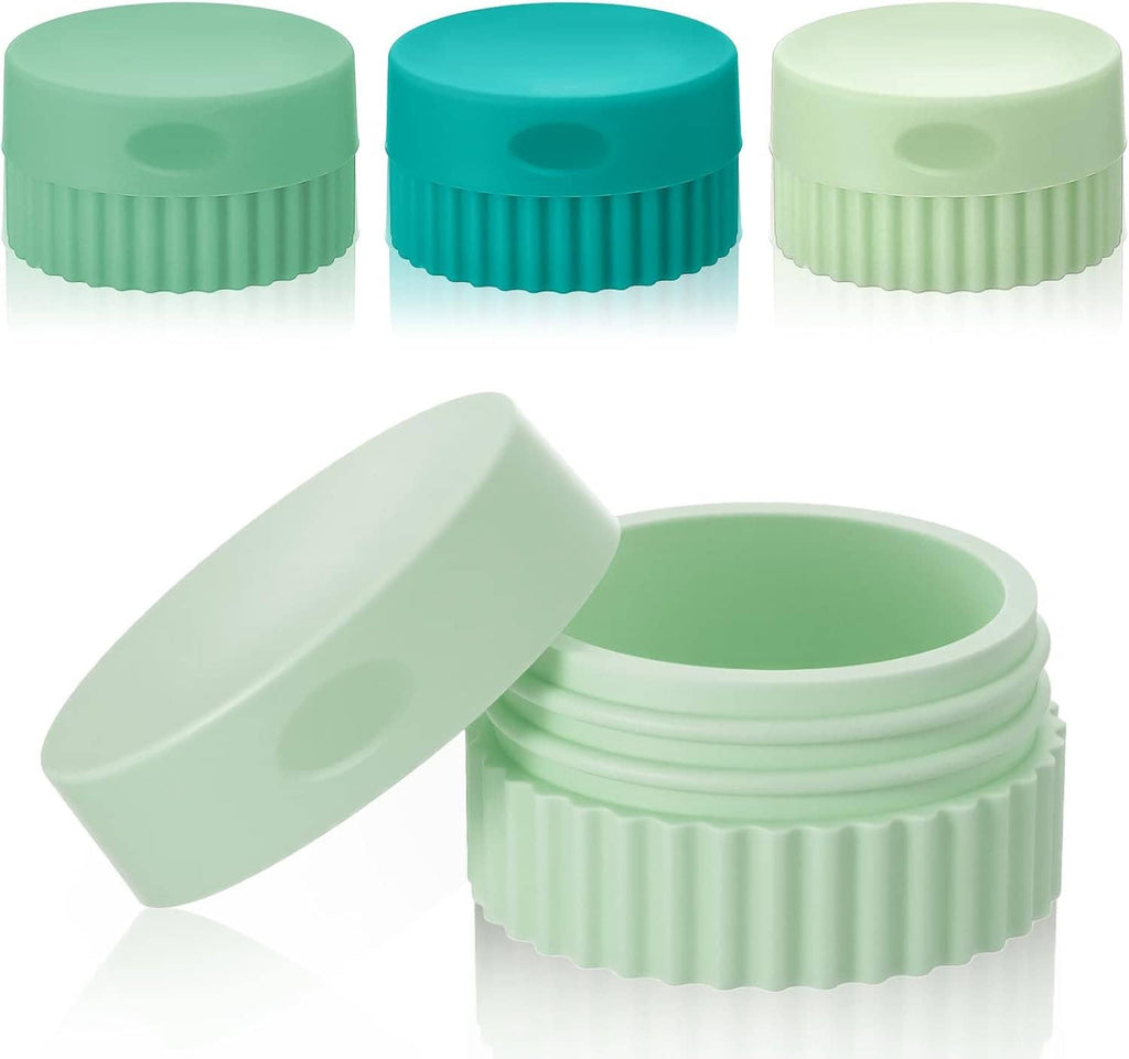 Set of small silicone travel jars, teal and mint green with ribbed lids