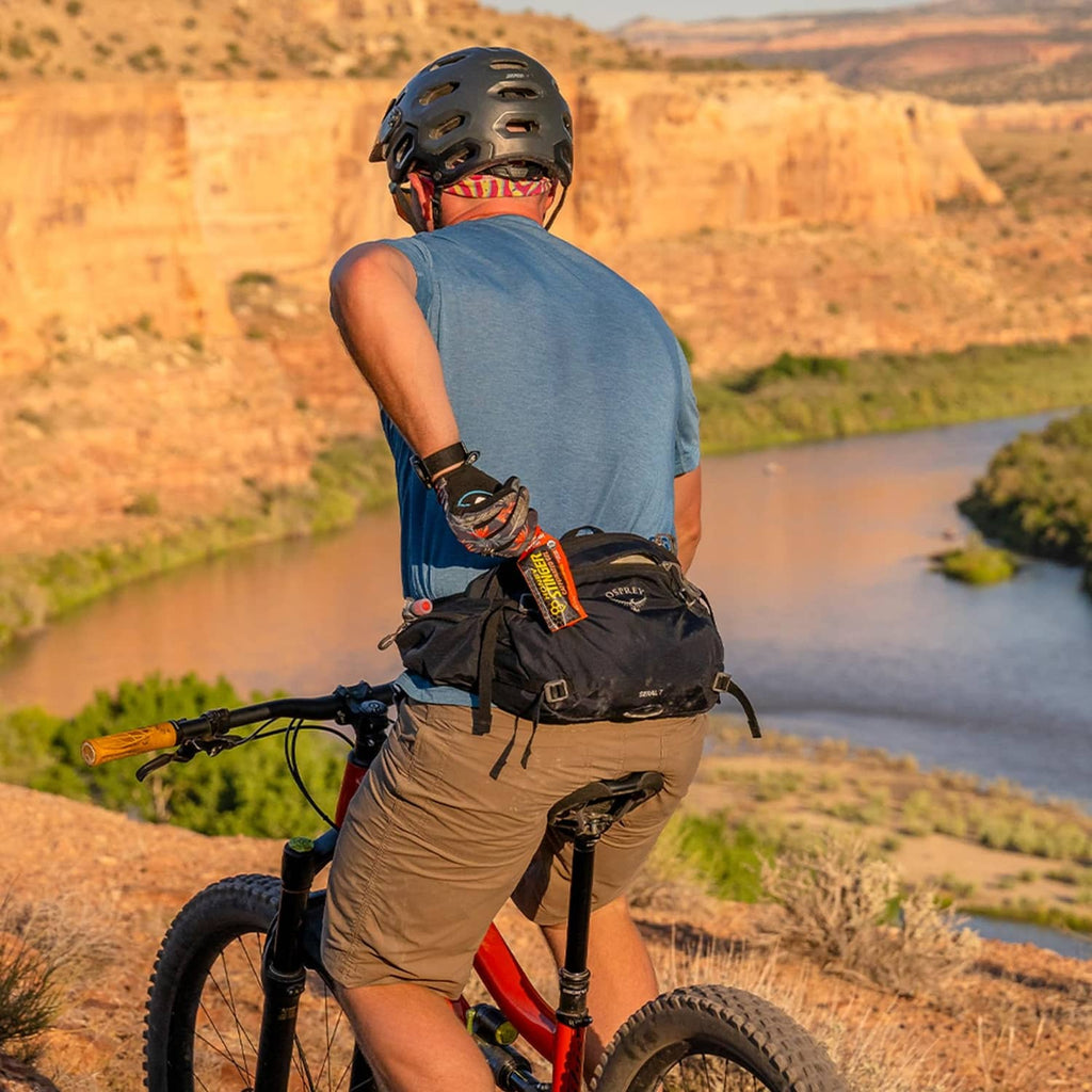 Cyclist with a small energy gel packet on a bike during an outdoor ride