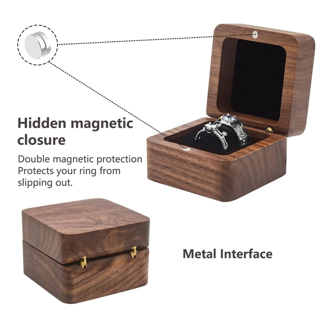 Small wooden ring box with hinged lid open, two black velvet pads and gold hinges