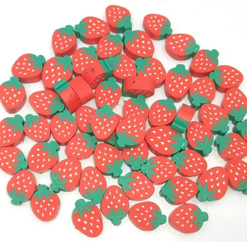 Strawberry-shaped polymer clay beads with red bodies and green leaf tops