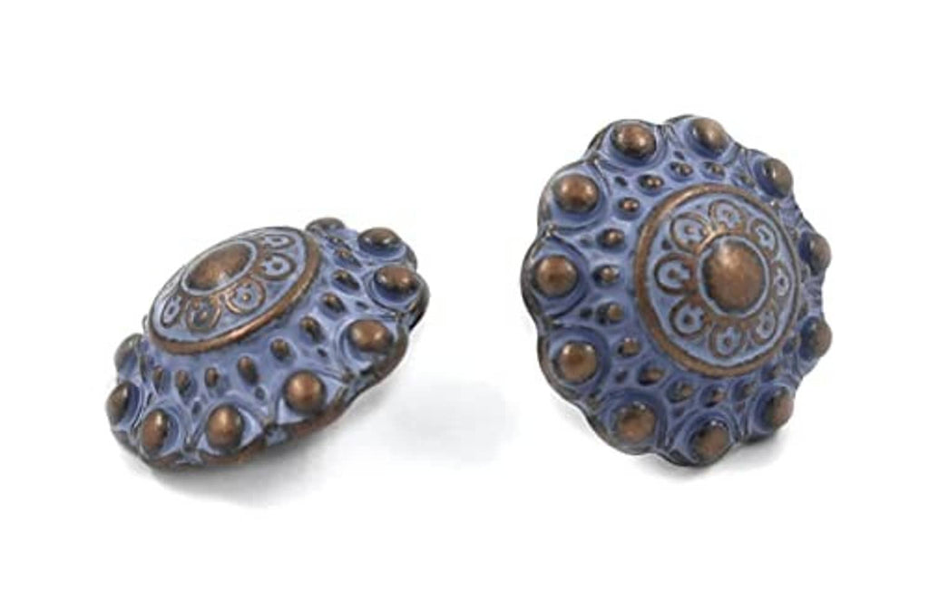Pair of blue engraved metal shank buttons with bronze-tone domed studs and central medallion