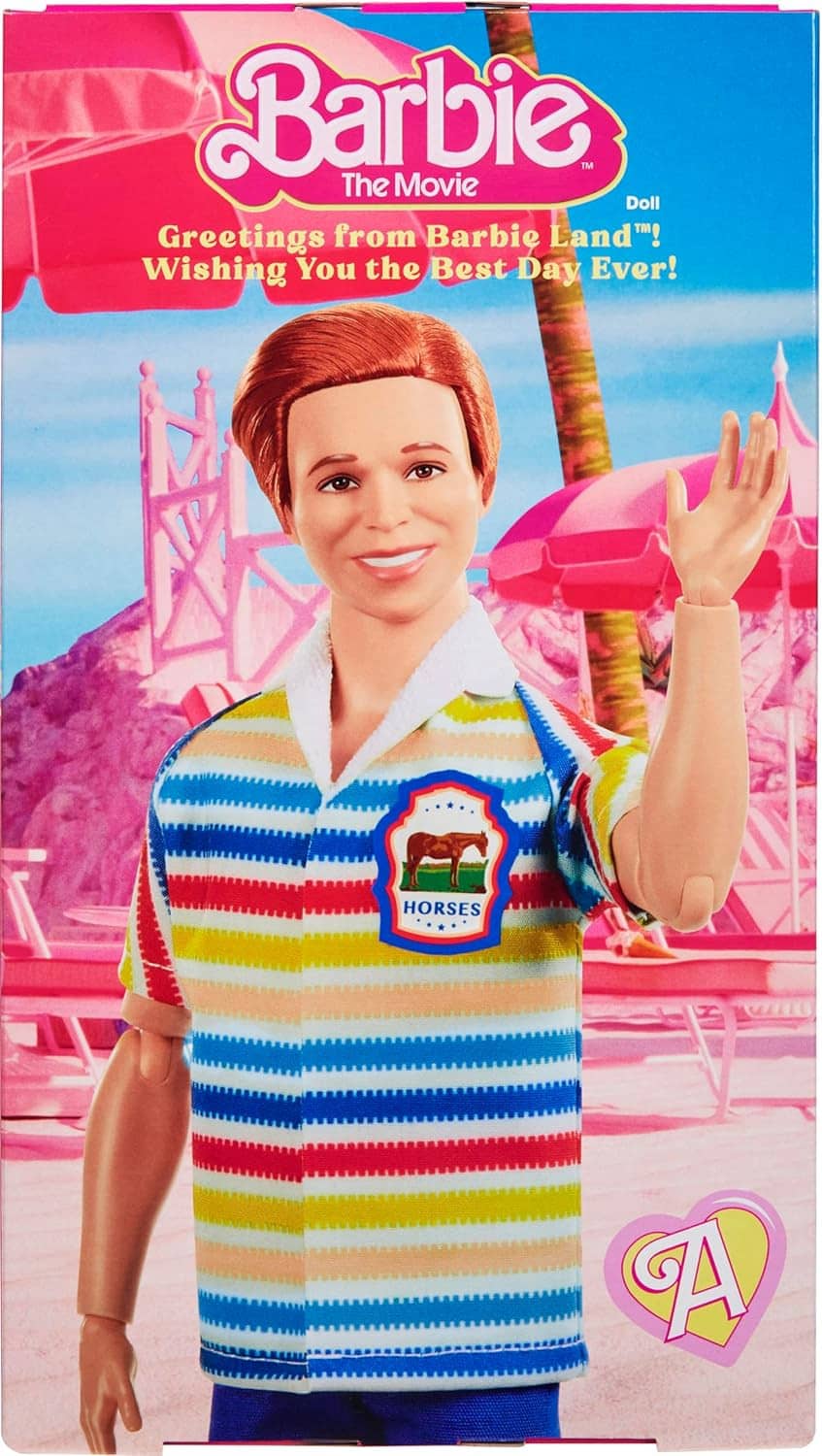 Collectible doll in a rainbow striped shirt displayed in packaging