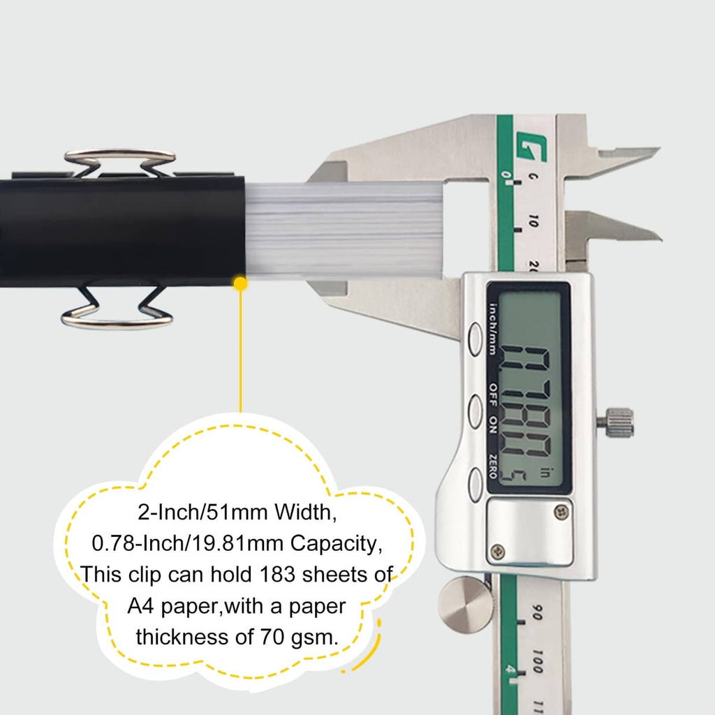 Black 2-inch binder clip shown clamping paper with digital caliper measurement