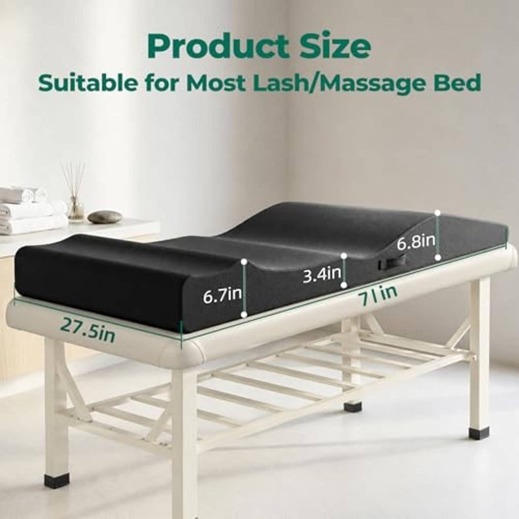 Black curvy foam topper for lash or massage beds on a white folding table
