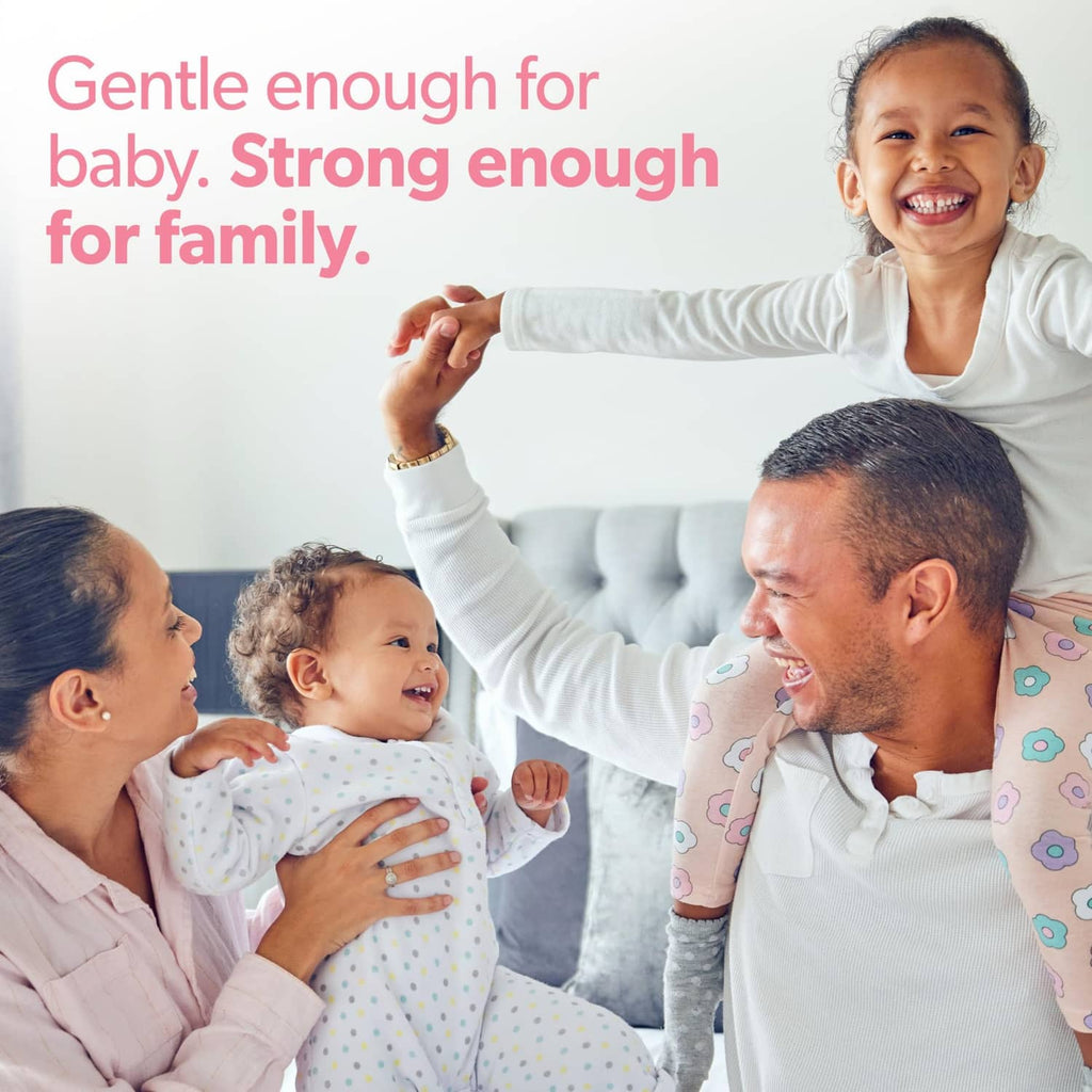 Smiling family with a baby standing and arms reaching