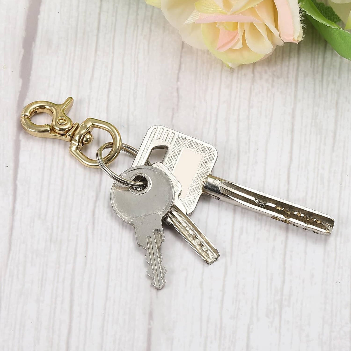 Brass lobster clasp keychain holding metal keys on ring