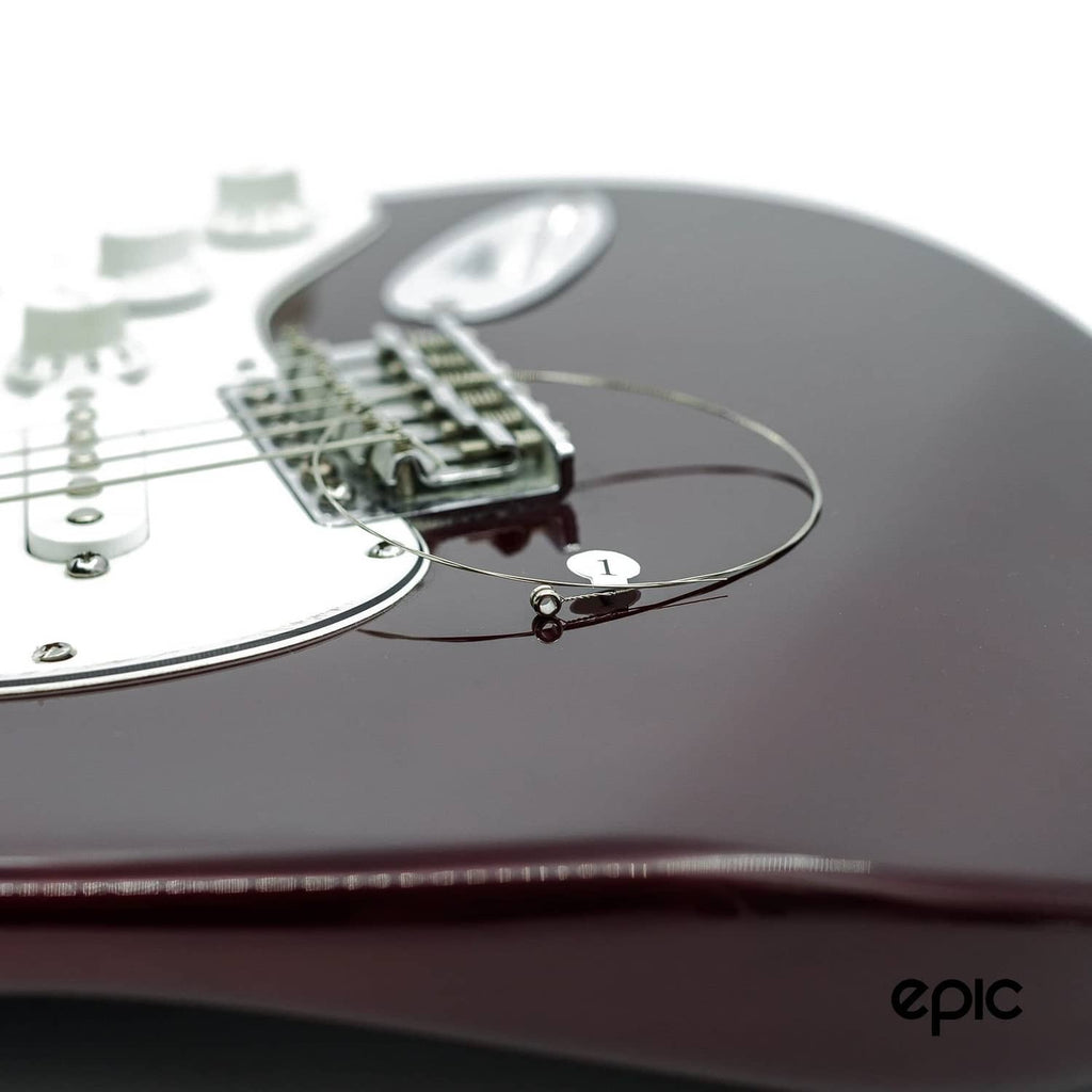 Electric guitar with installed string loop and bridge pickup area