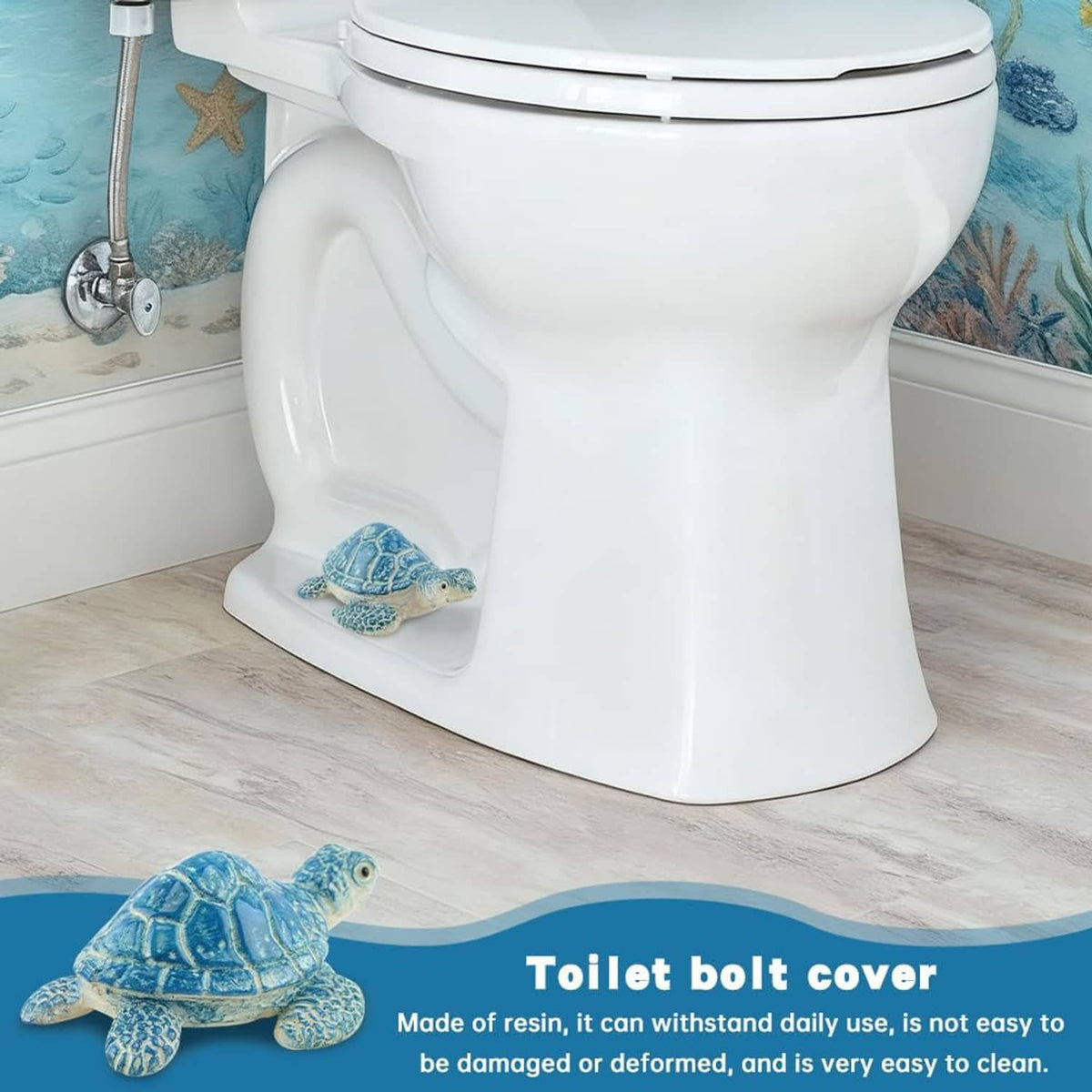 Blue turtle-shaped toilet bolt cover on the floor beside a white toilet