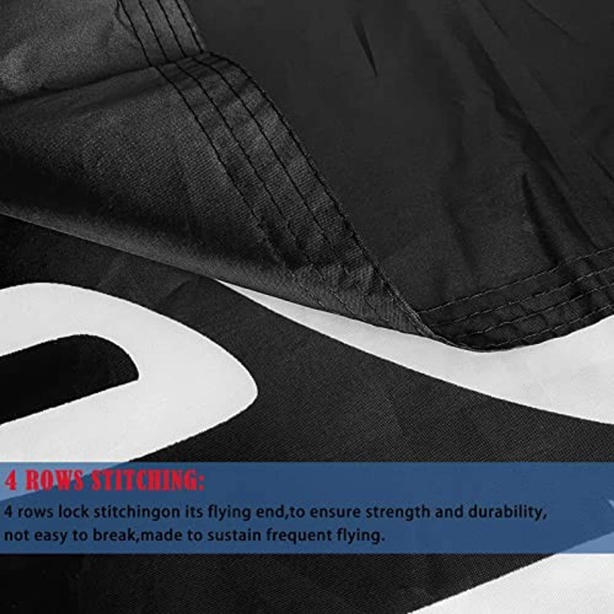 Black flag edge close-up with stitched border seam and textured fabric.