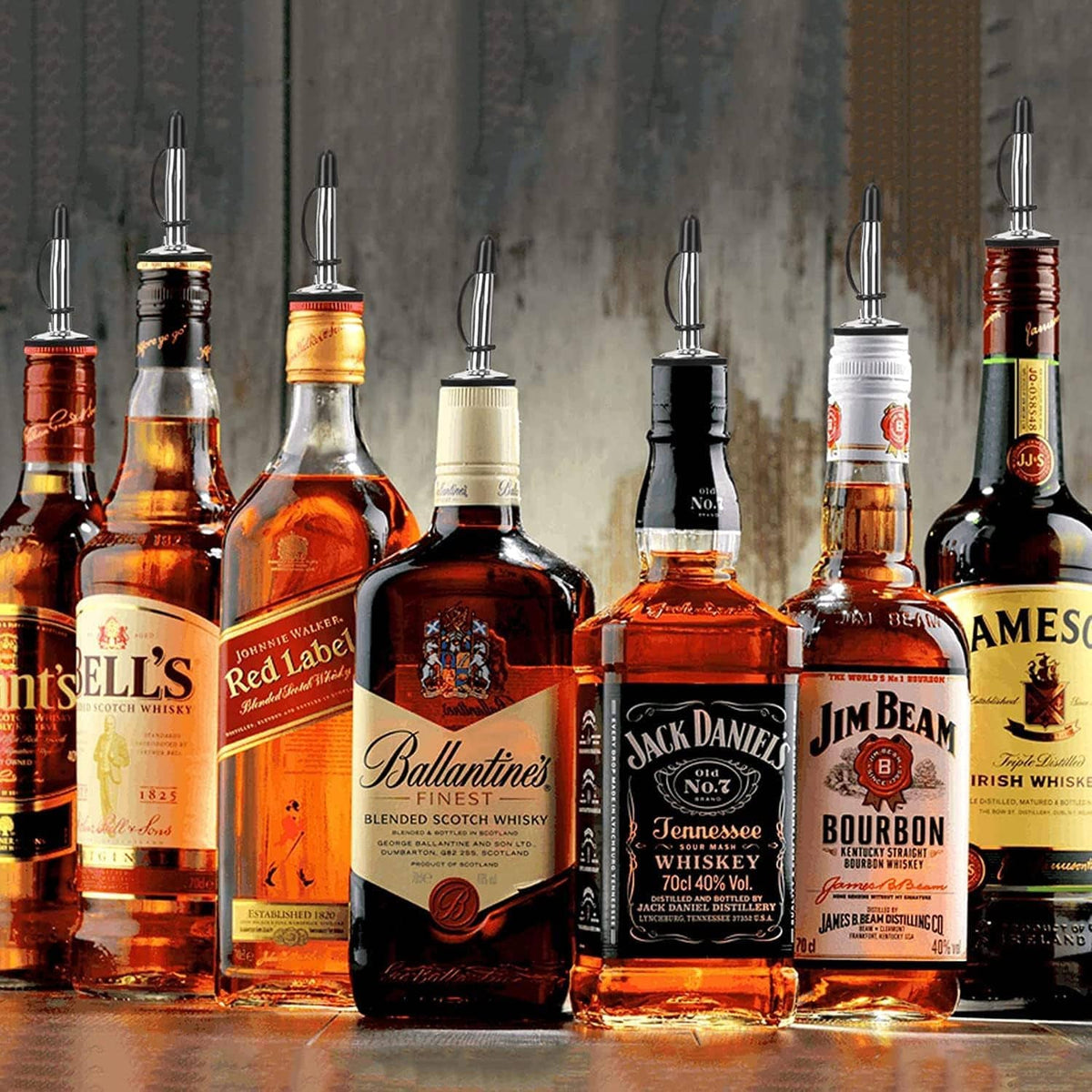 Multiple bottle pour spouts with black caps placed on bottles