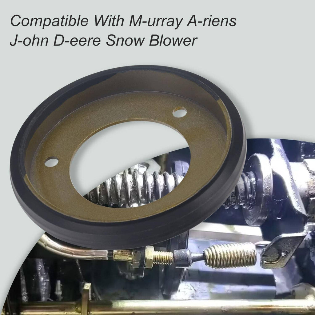 Black friction wheel disc with bronze center and three mounting holes, mounted on equipment