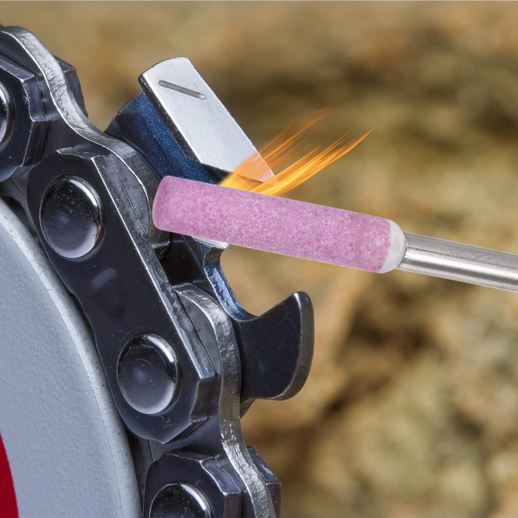 Chainsaw grinder sharpening with pink diamond abrasive bit, sparks at contact point