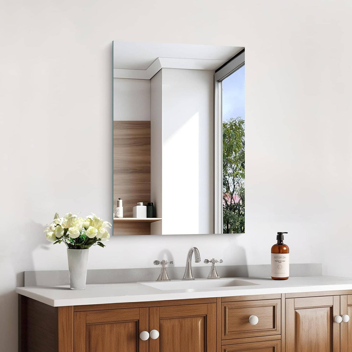 Rectangular frameless bathroom mirror with silver edge and clear reflection