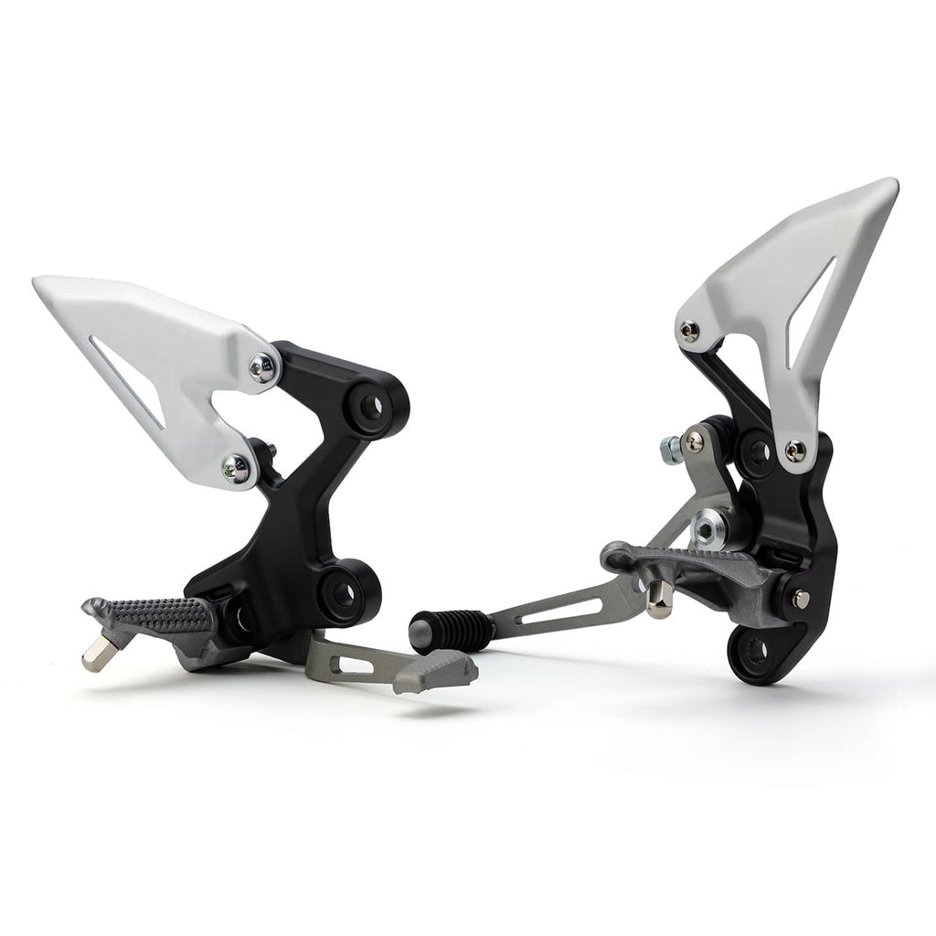 Motorcycle foot peg bracket pair with silver plates, black mounts, and textured rubber pegs