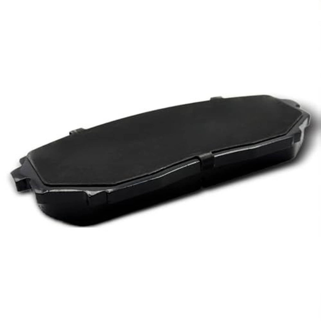 Ceramic brake pad shown from the black backing side with mounting clips, angled view