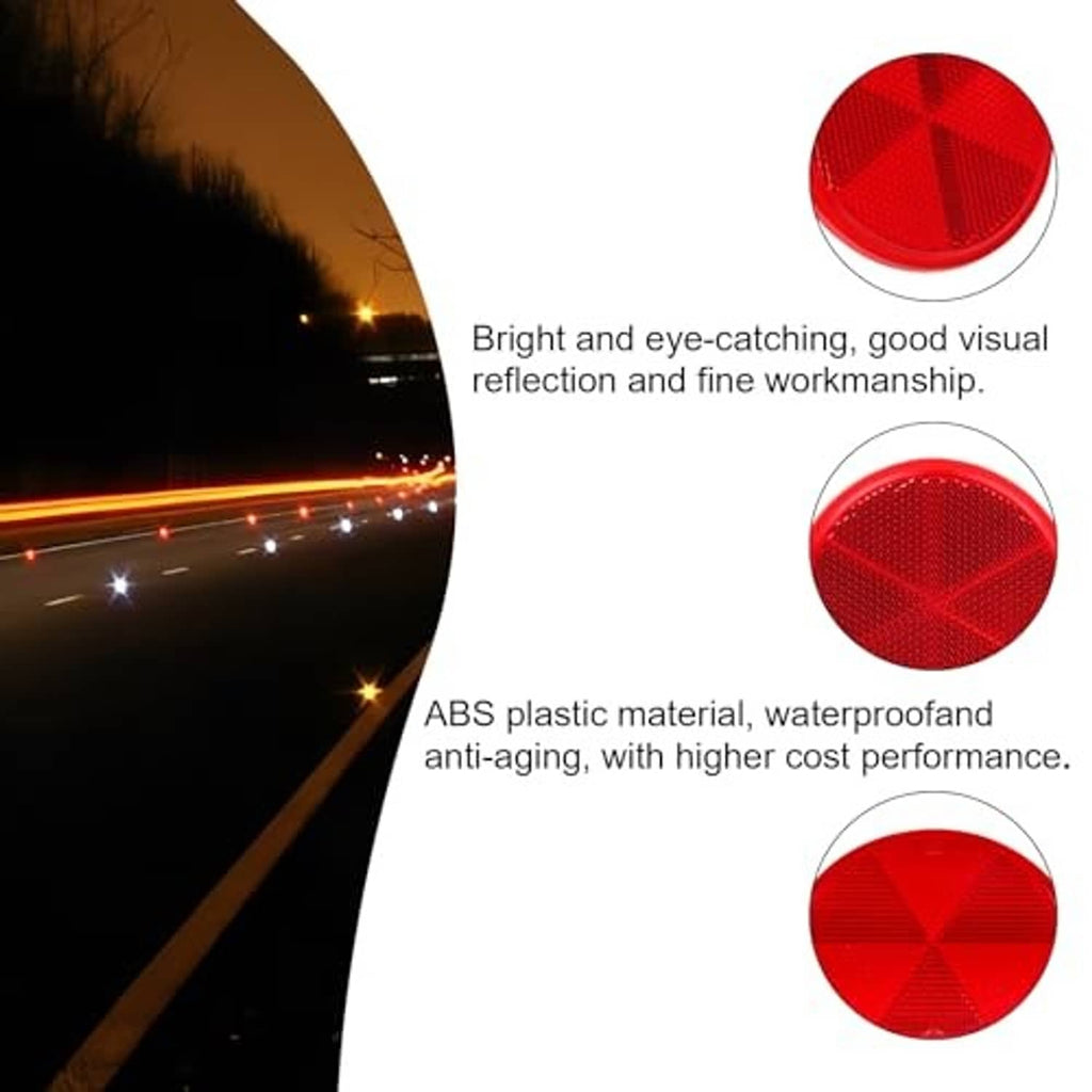 Red round self-adhesive reflectors, close arrangement of three on a white surface