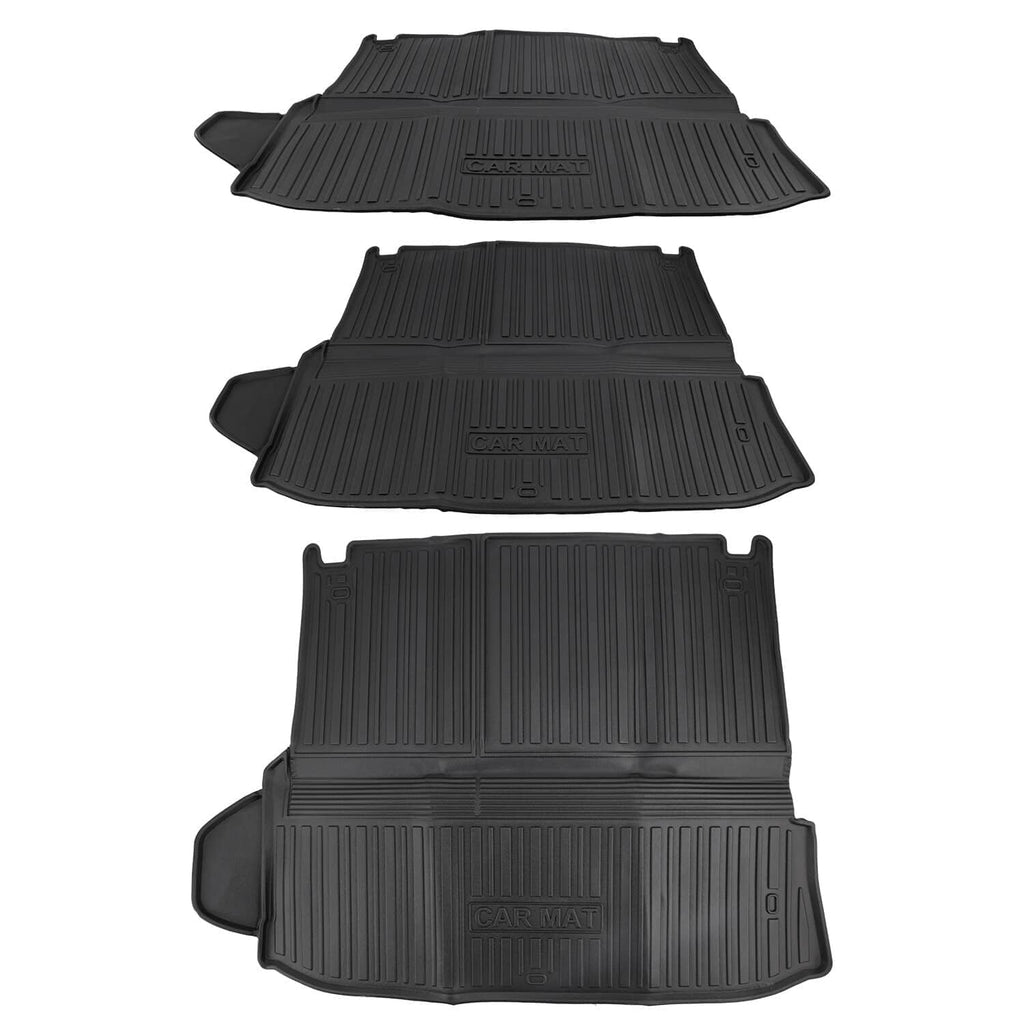 Black molded vehicle floor mats stacked, showing embossed logos on the surfaces