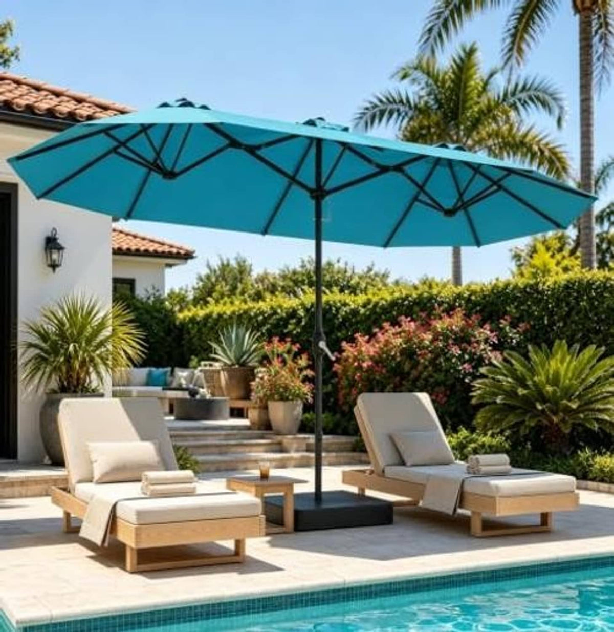 Teal patio umbrella canopy with multiple ribs and upright central pole over deck chairs