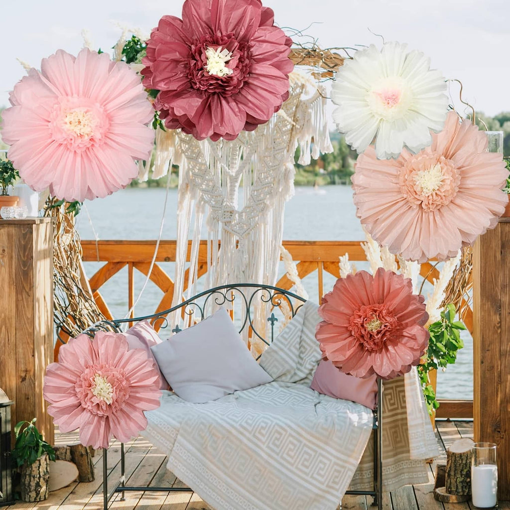 Giant tissue paper flowers arranged as party backdrop decor in pink and white