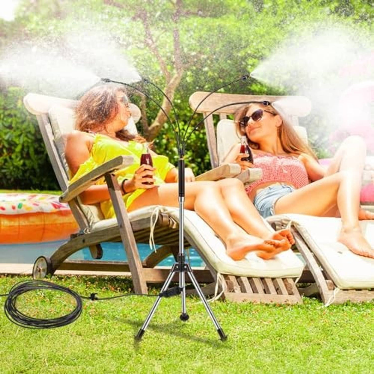 Tripod patio misting tower spraying mist over two people relaxing on lawn chairs.