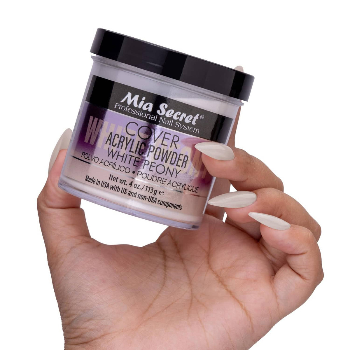 Mia Secret Cover acrylic powder jar held in hand, white peony shade, clear label
