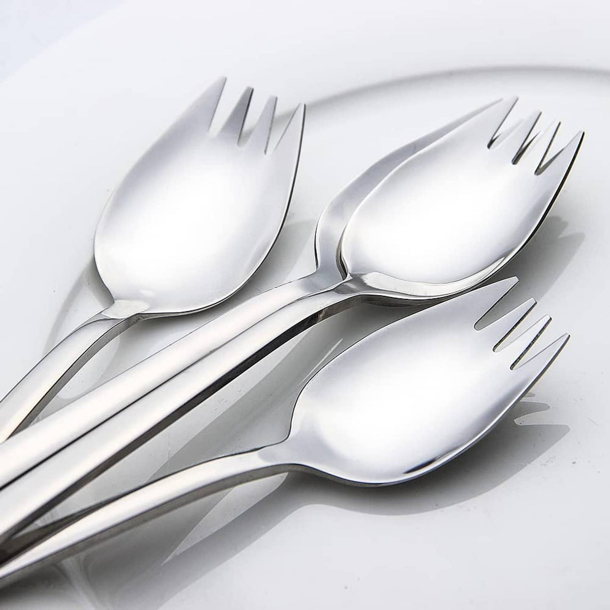 Metal sporks fanned out, spoon bowls with four fork tines