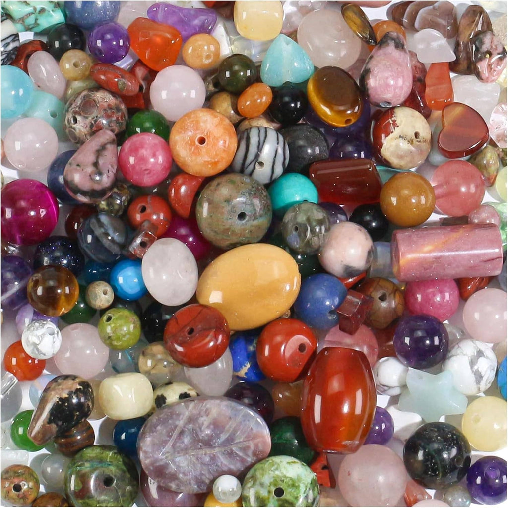 Mixed semi-precious stone beads with varied oval, round, and carved shapes in many colors
