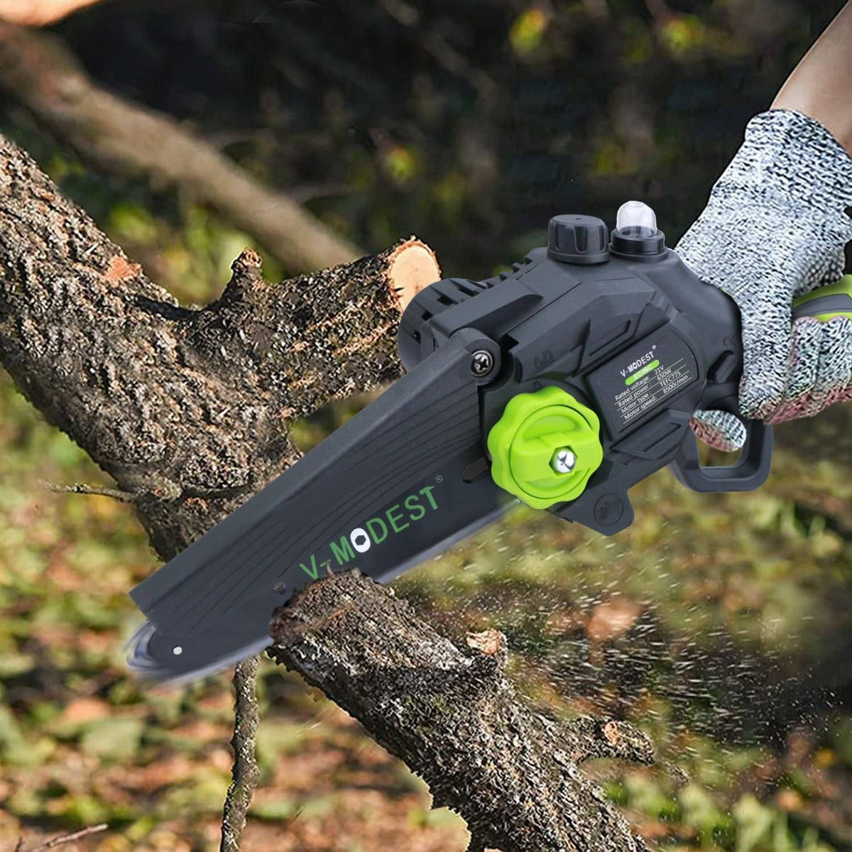 Replacement saw chain on a chainsaw bar cutting a branch, with green V-MODEST label