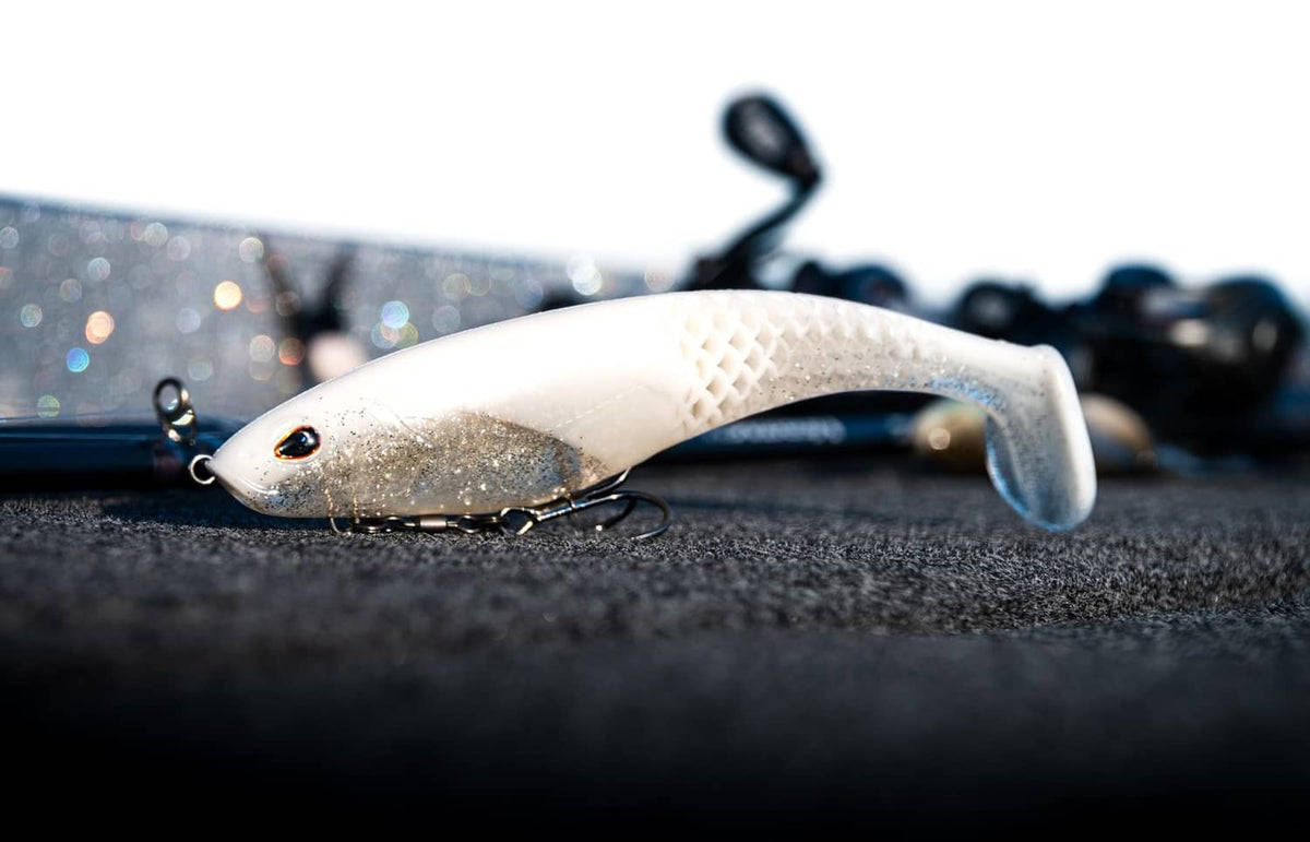 Soft plastic swimbait lure, light white-beige body with dark eye and hook